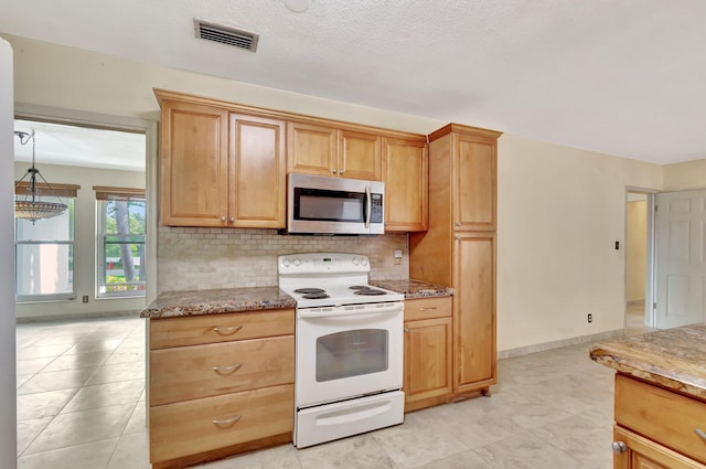 kitchen featuring electric range, tasteful backsplash, visible vents, and stainless steel microwave