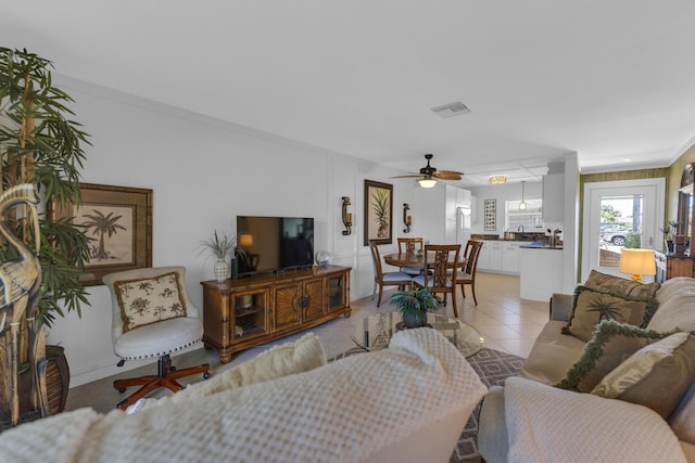 living room featuring light tile patterned floors and visible vents