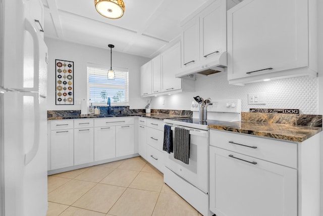 kitchen with under cabinet range hood, a sink, white appliances, white cabinets, and light tile patterned floors