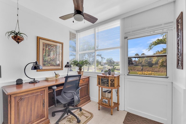 home office featuring light tile patterned floors and ceiling fan