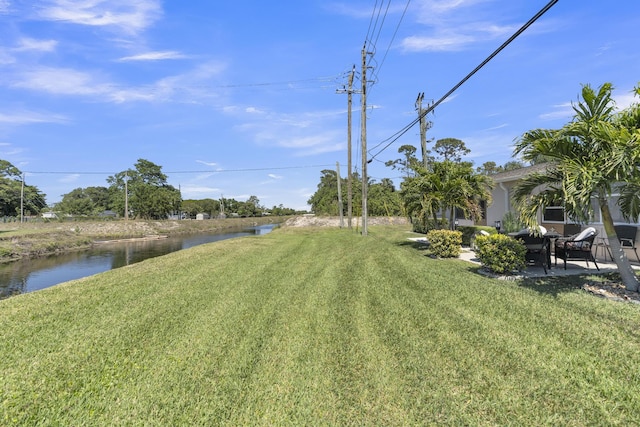 view of yard with a patio area and a water view