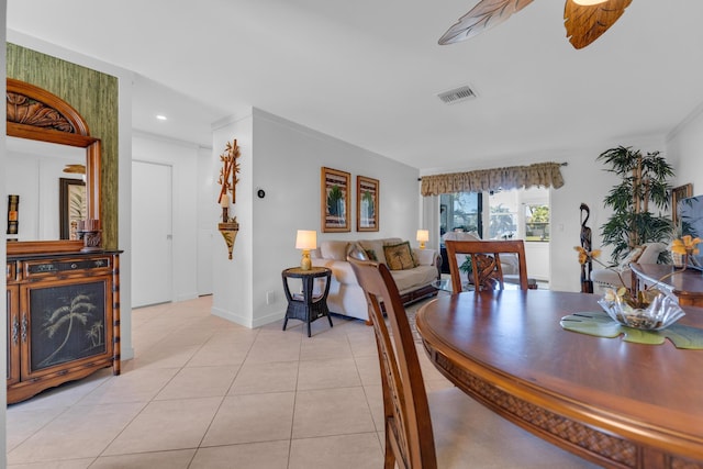 dining area with light tile patterned floors, visible vents, baseboards, and a ceiling fan