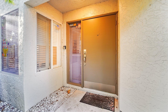 doorway to property with stucco siding