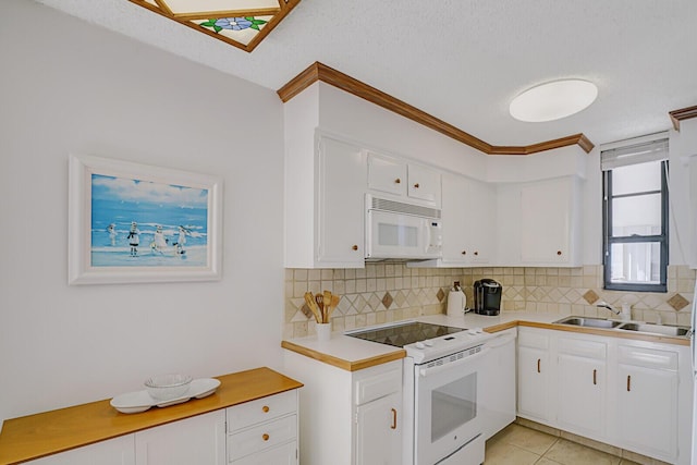 kitchen featuring white appliances, a sink, light countertops, white cabinets, and backsplash