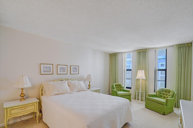 bedroom with a textured ceiling and light carpet