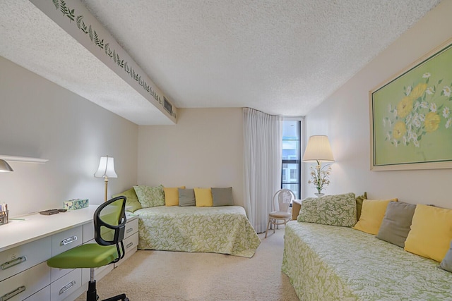 carpeted bedroom featuring a textured ceiling