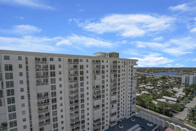 view of building exterior featuring a city view and a water view