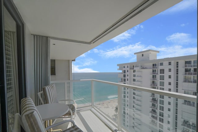 balcony with a view of the beach and a water view