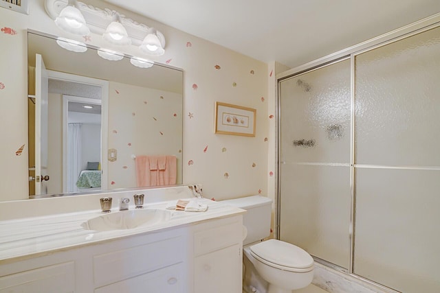 ensuite bathroom with a shower stall, ensuite bathroom, toilet, and vanity