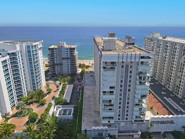 birds eye view of property with a view of city and a water view