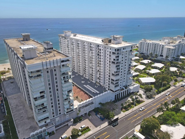 birds eye view of property featuring a water view and a view of city