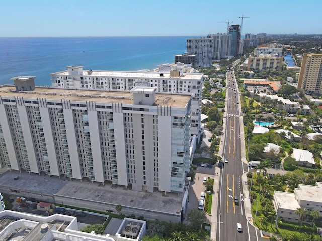 drone / aerial view featuring a city view and a water view