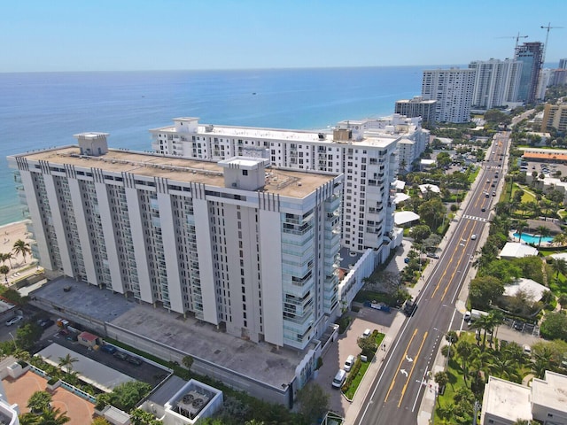 birds eye view of property with a water view and a view of city