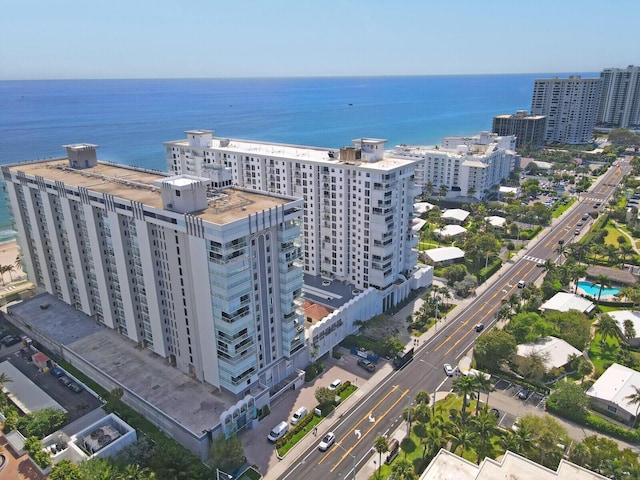 birds eye view of property with a water view and a city view