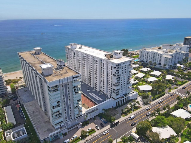 birds eye view of property with a view of city and a water view