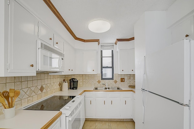 kitchen with white appliances, light countertops, crown molding, and a sink