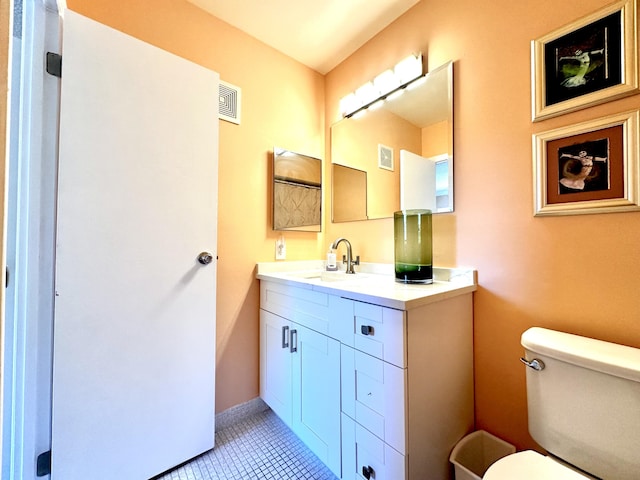 bathroom with visible vents, baseboards, toilet, and vanity