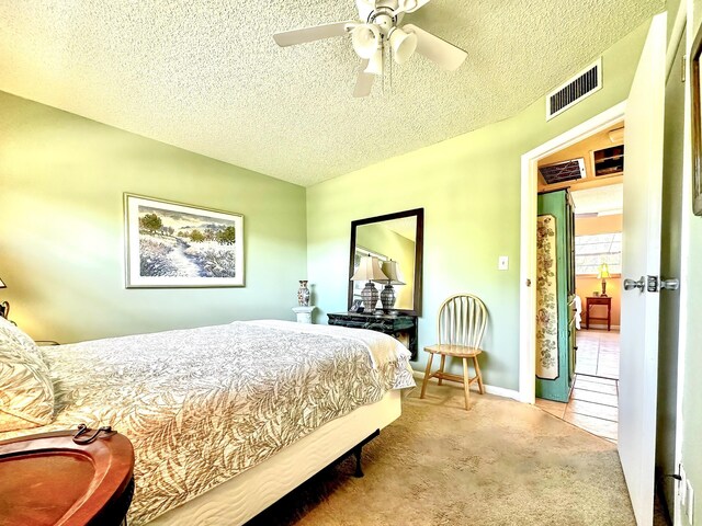 carpeted bedroom with visible vents, baseboards, a textured ceiling, and ceiling fan