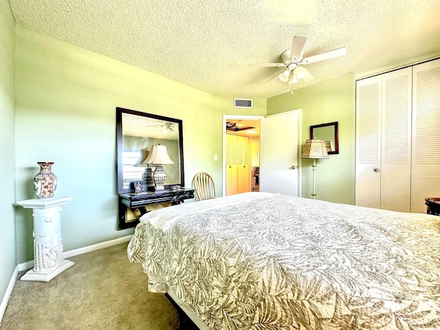 carpeted bedroom with visible vents, a textured ceiling, a closet, baseboards, and ceiling fan