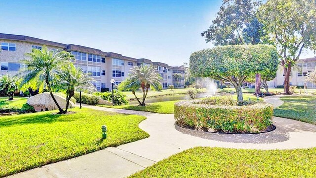 view of home's community featuring a lawn