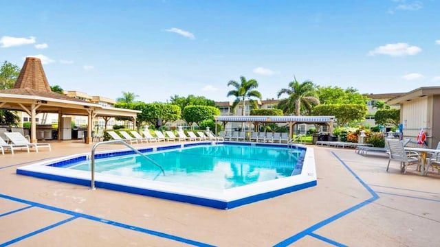 view of pool featuring a patio and fence