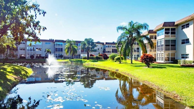 surrounding community featuring a yard and a water view