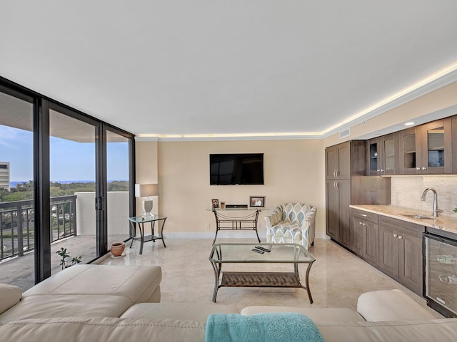 living room with wine cooler, visible vents, floor to ceiling windows, and baseboards