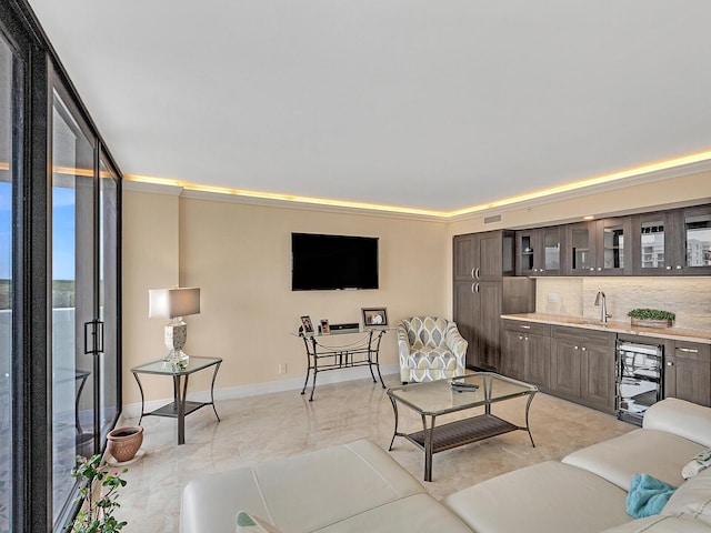 living area with visible vents, baseboards, wet bar, and beverage cooler