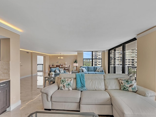 living room with an inviting chandelier, baseboards, and marble finish floor