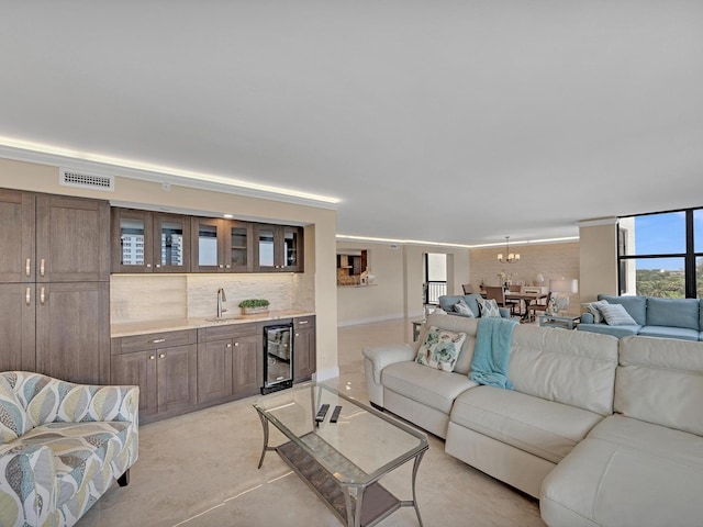 living room featuring wet bar, beverage cooler, and visible vents