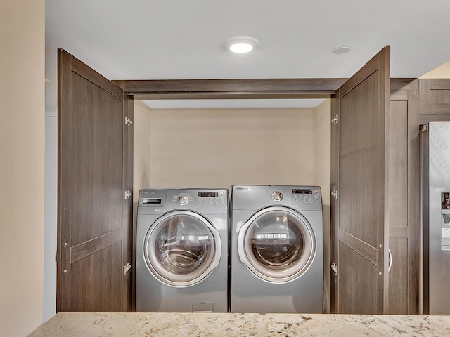 washroom with separate washer and dryer and laundry area