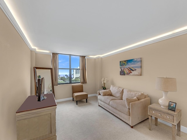 living area featuring baseboards, light carpet, and ornamental molding