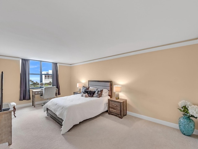 carpeted bedroom featuring baseboards and crown molding