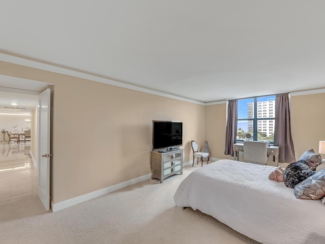 bedroom with light carpet, crown molding, and baseboards