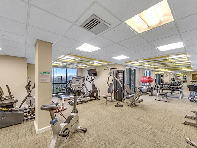 exercise room featuring visible vents, carpet flooring, and baseboards