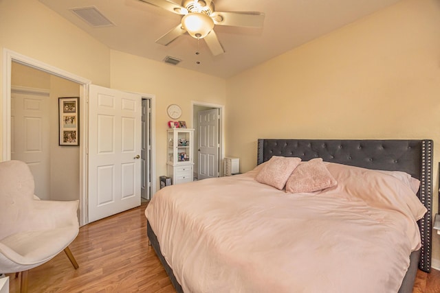 bedroom featuring visible vents, ceiling fan, and wood finished floors