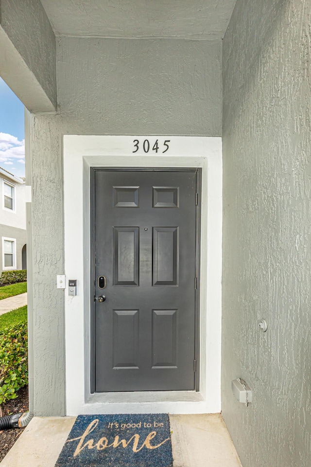 property entrance featuring stucco siding