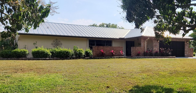 ranch-style home featuring a front yard, a garage, and stucco siding