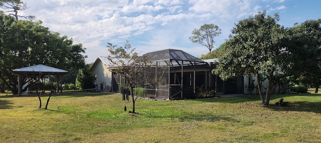 view of yard with glass enclosure and a gazebo