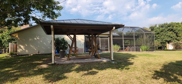 view of yard featuring a patio area and glass enclosure