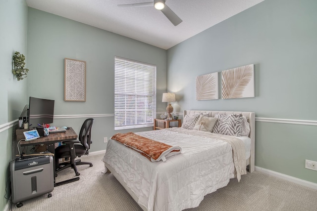 bedroom with ceiling fan, baseboards, and carpet