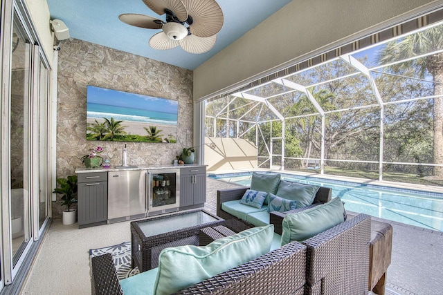 view of patio / terrace featuring a ceiling fan, an outdoor pool, wine cooler, outdoor lounge area, and a lanai