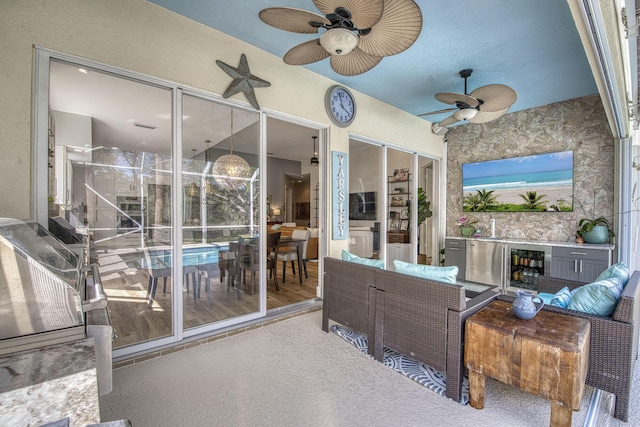 sunroom / solarium with wine cooler and ceiling fan