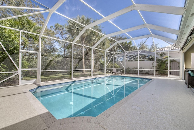 view of pool with a patio area, a fenced in pool, and a lanai