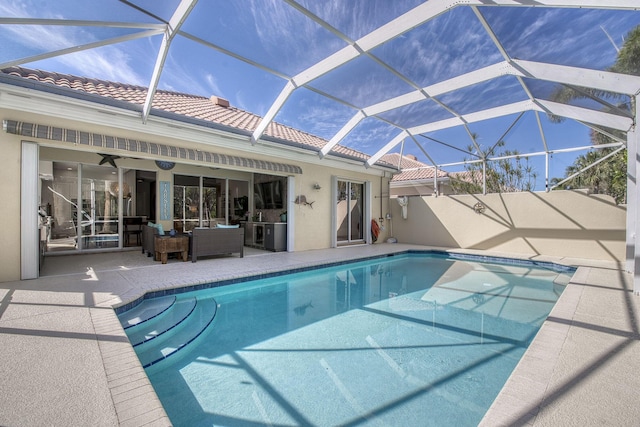 outdoor pool featuring a patio area and glass enclosure