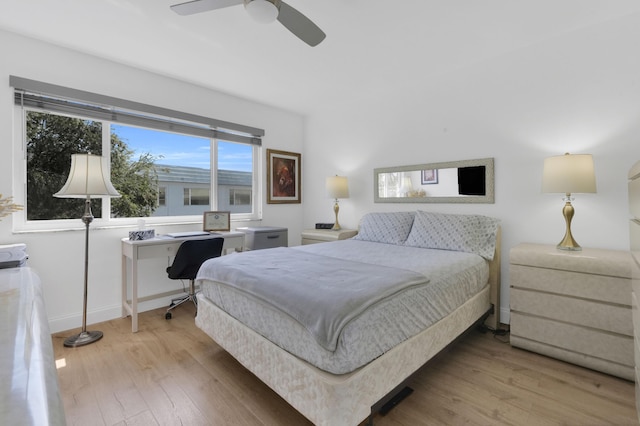 bedroom featuring wood finished floors, baseboards, and ceiling fan