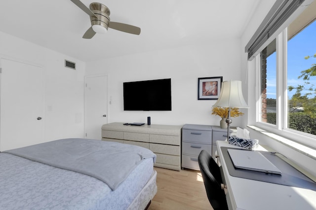 bedroom with ceiling fan, visible vents, and light wood-type flooring