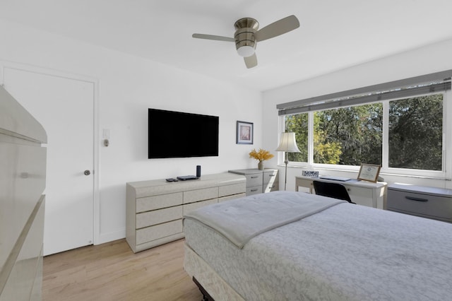 bedroom with light wood-style flooring and a ceiling fan