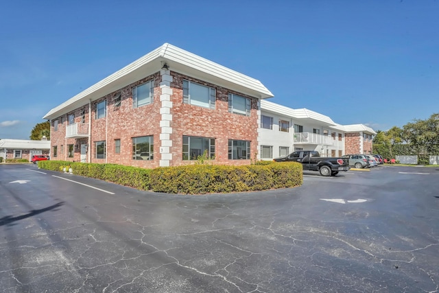 view of building exterior with uncovered parking