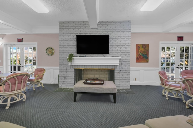 living room with beamed ceiling, french doors, carpet floors, and a textured ceiling